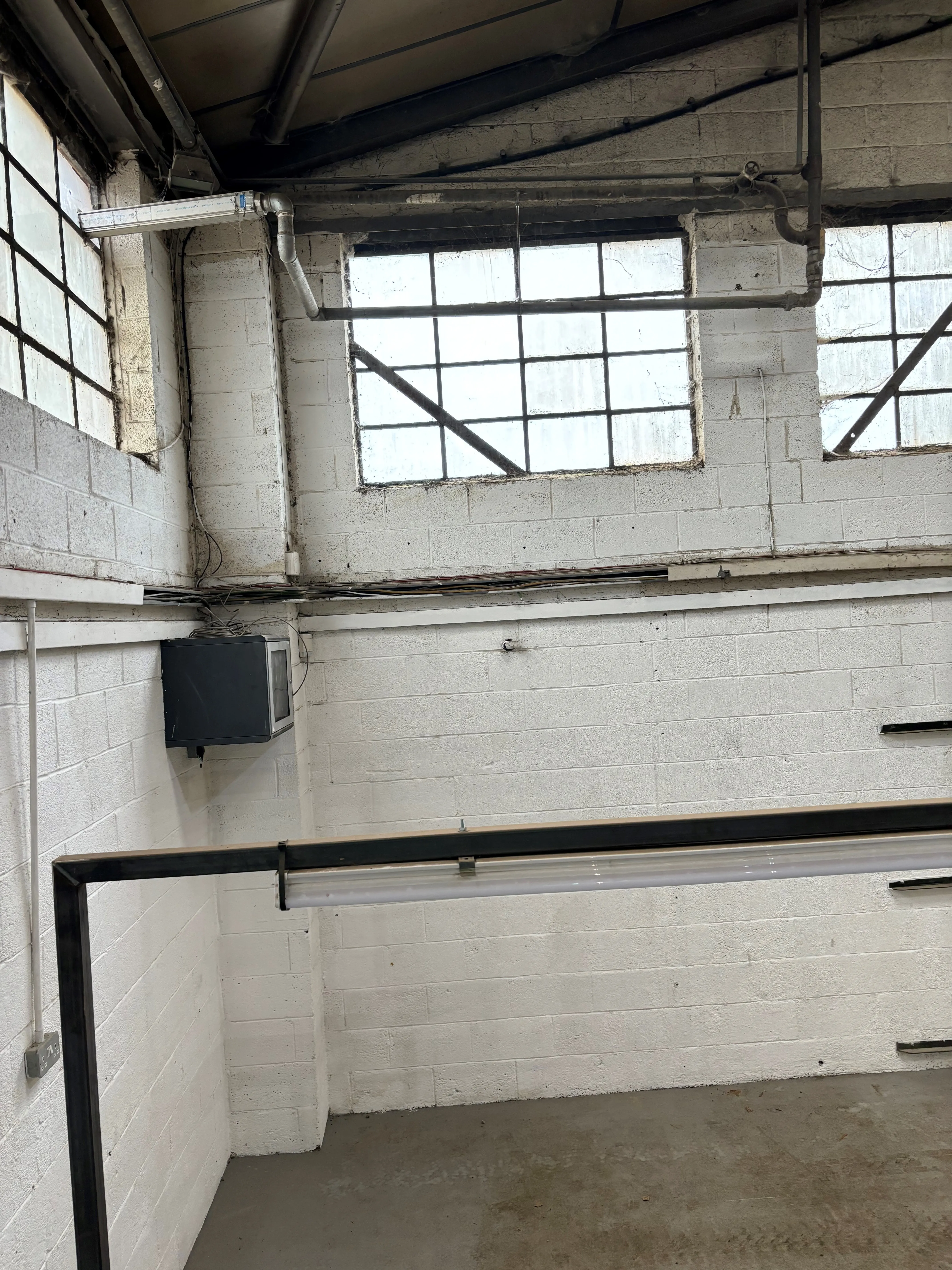 there is a room with a bench and a window in it