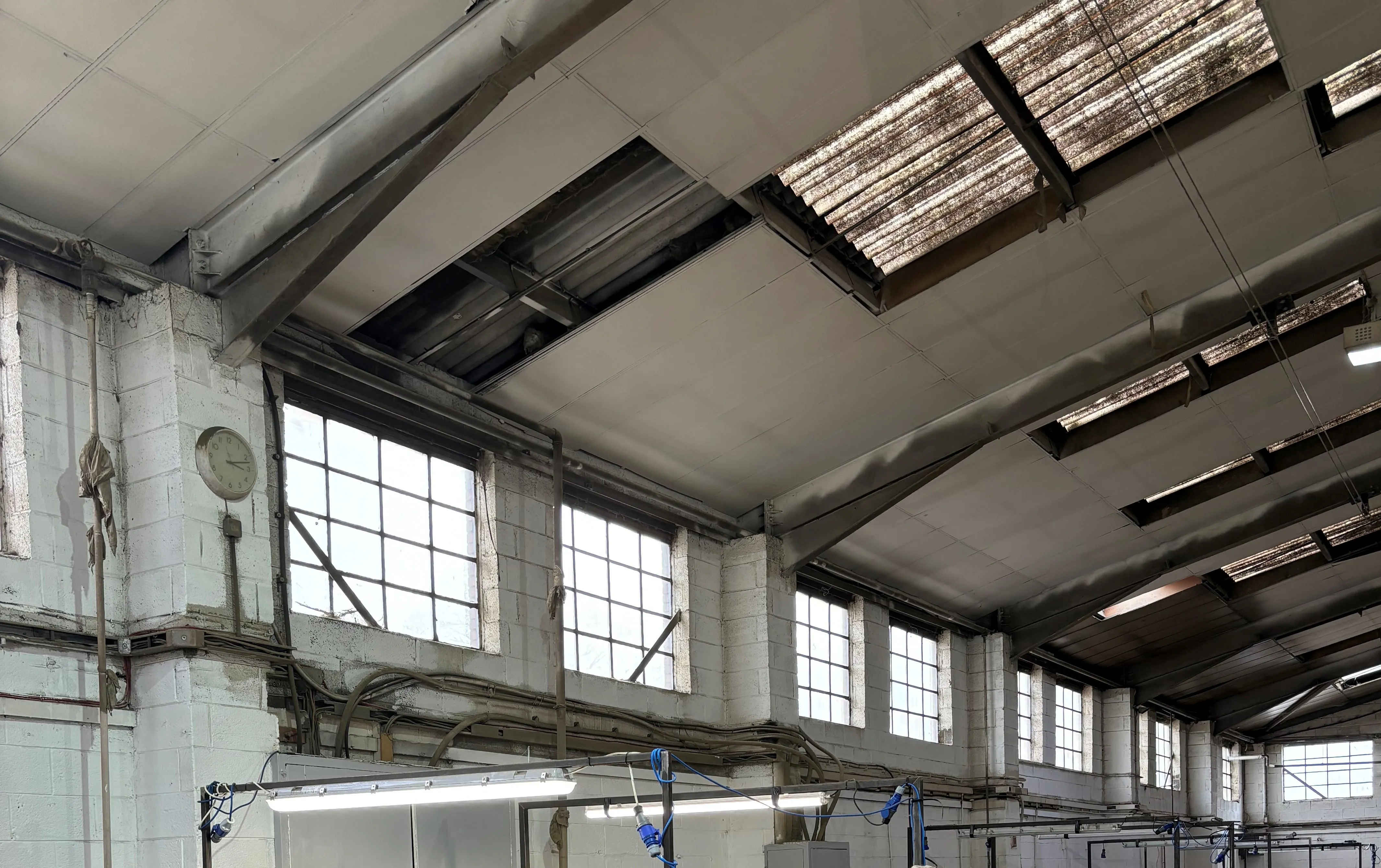 there is a large room with a lot of windows and a white truck
