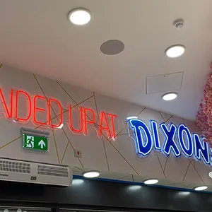a neon sign above a dixon store