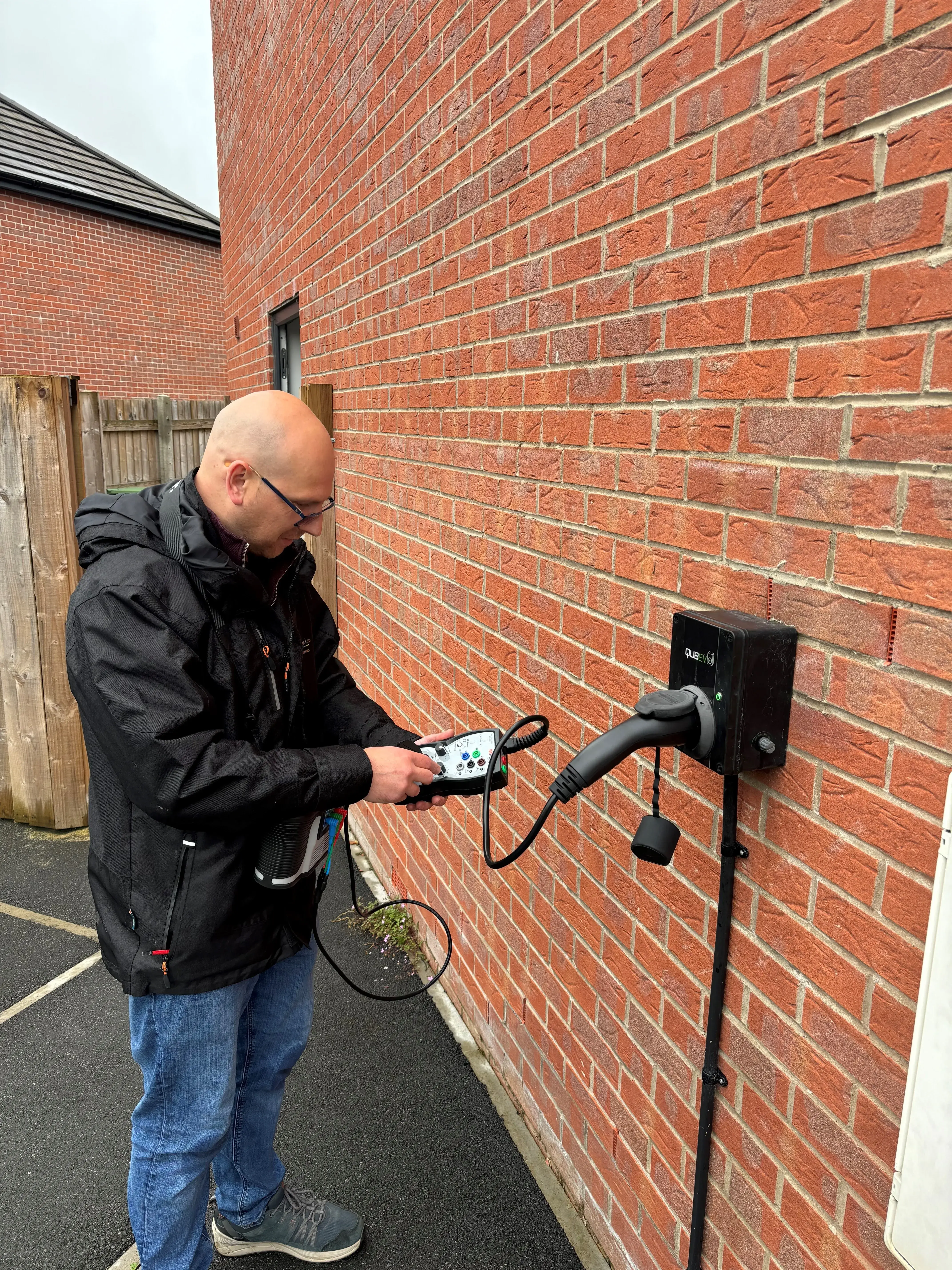 man using a corded device to connect a brick wall