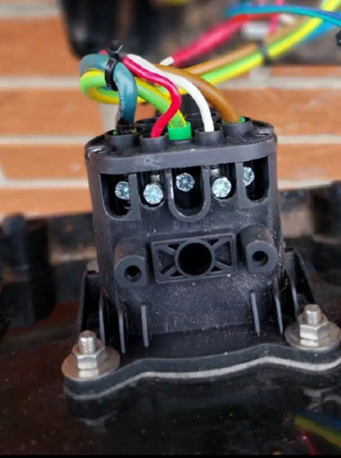 a close up of a black electrical device with wires and wires