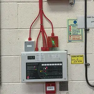 A control panel on the wall of a building.