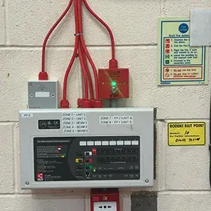 A control panel on a wall in a building.