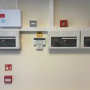 A room with a bunch of electrical equipment on the wall.