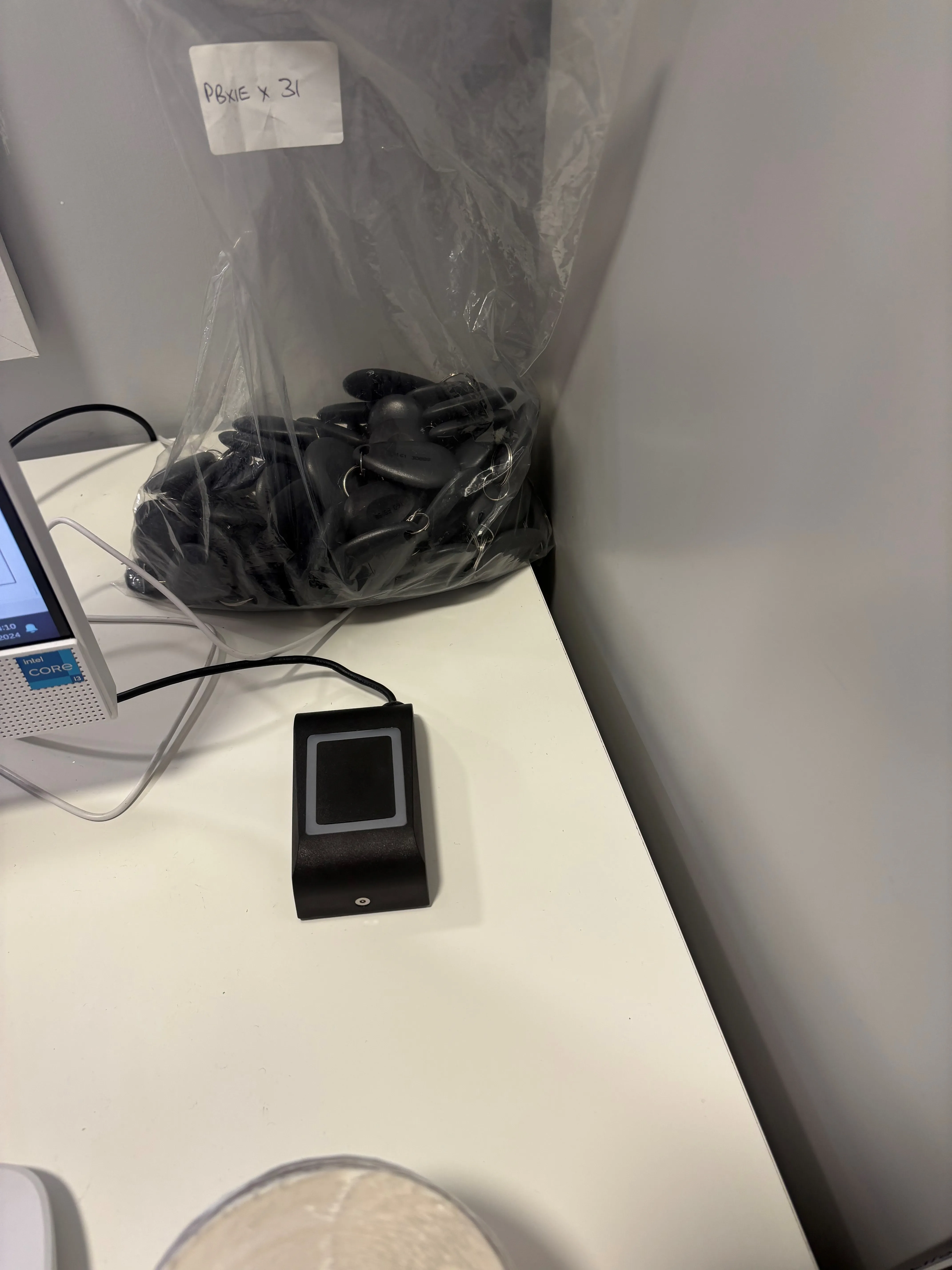 A computer monitor sitting on top of a white counter.