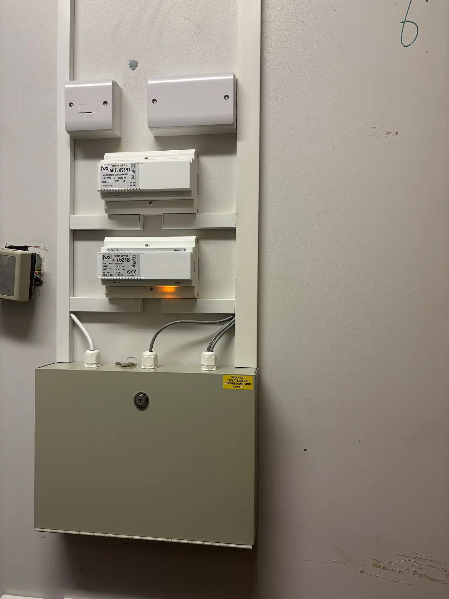 A wall mounted electrical device mounted to the side of a wall.
