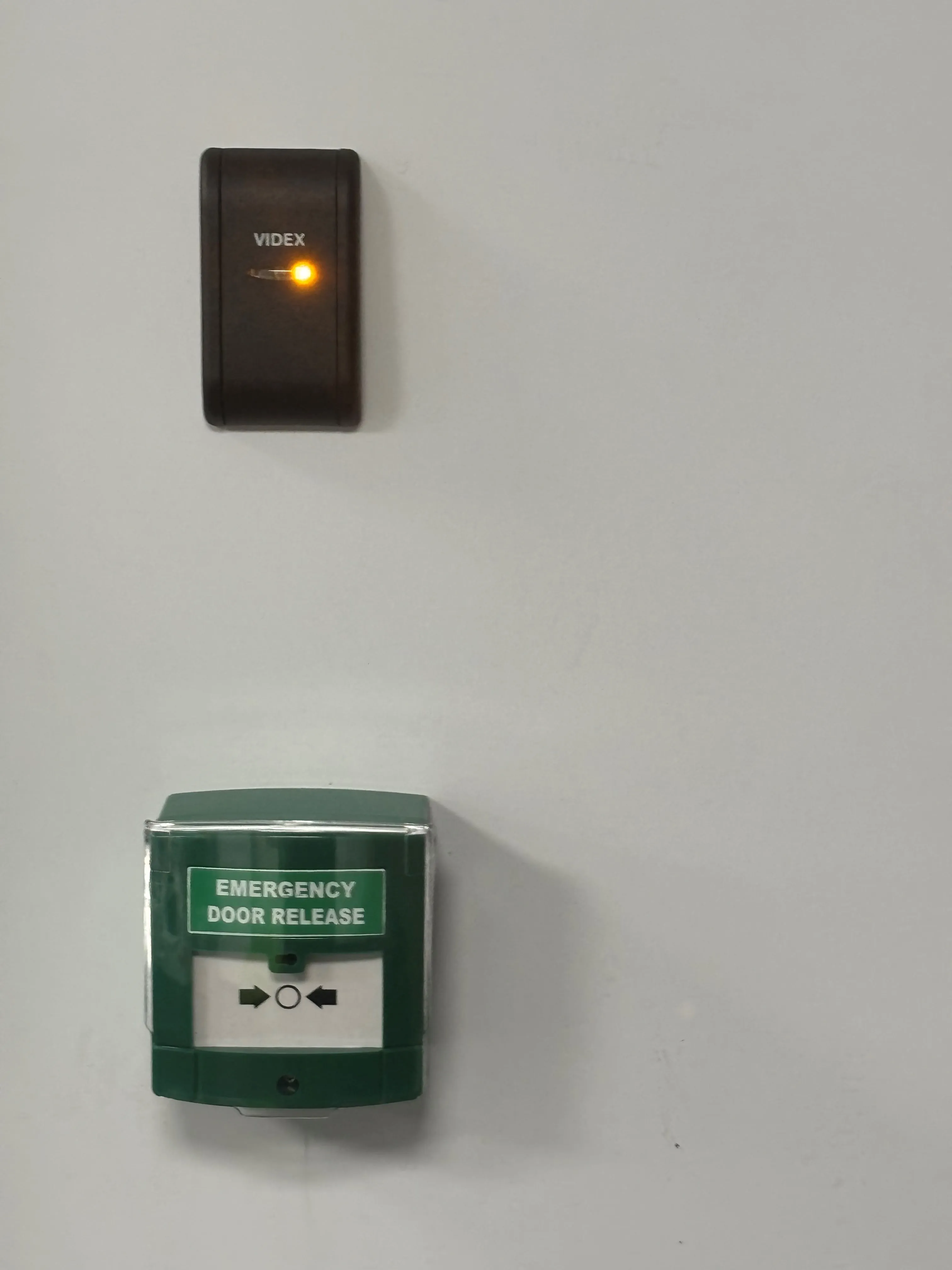 An emergency door release light on a wall.
