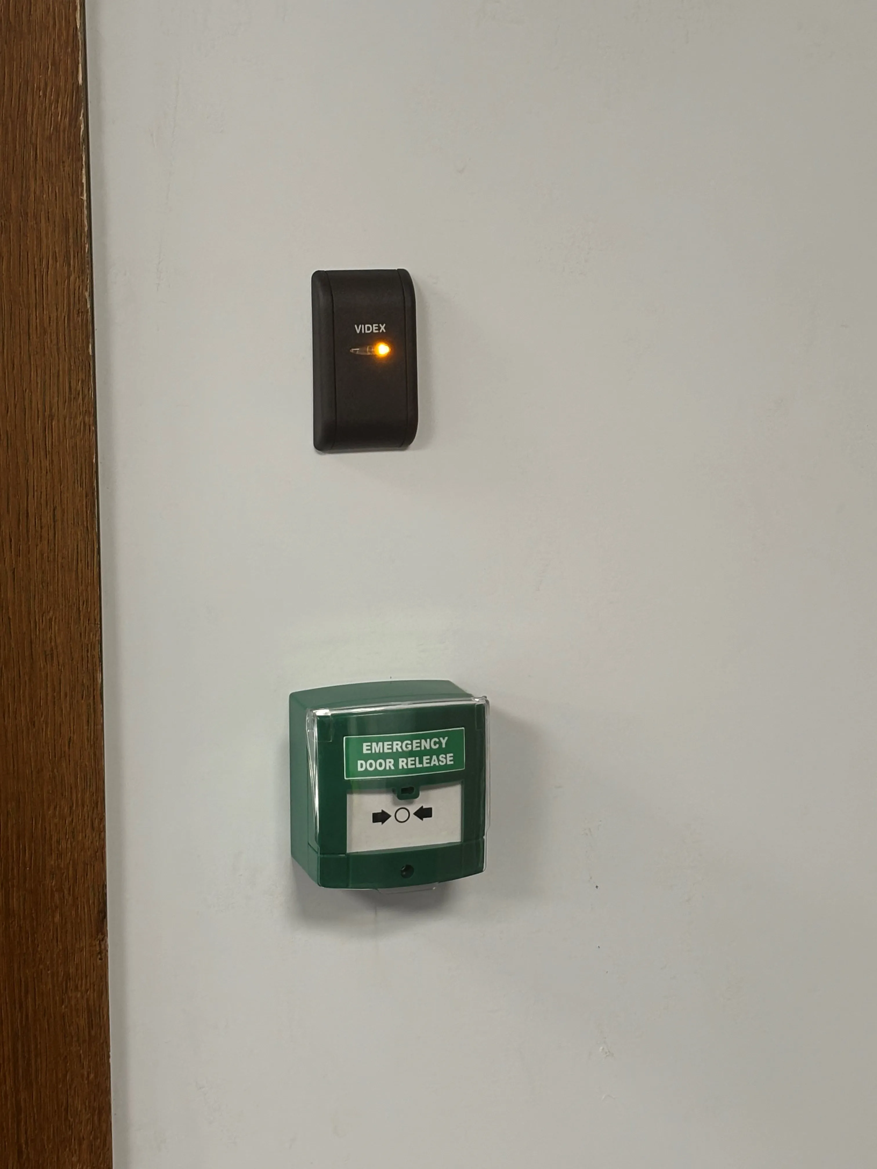 A green light switch on a white wall.