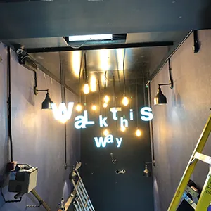 a long hallway with a neon sign on the wall