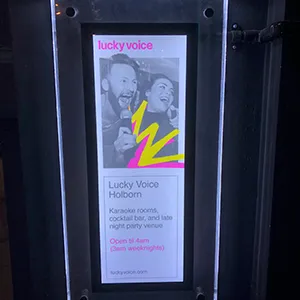 a ticket machine with a poster on the front of it